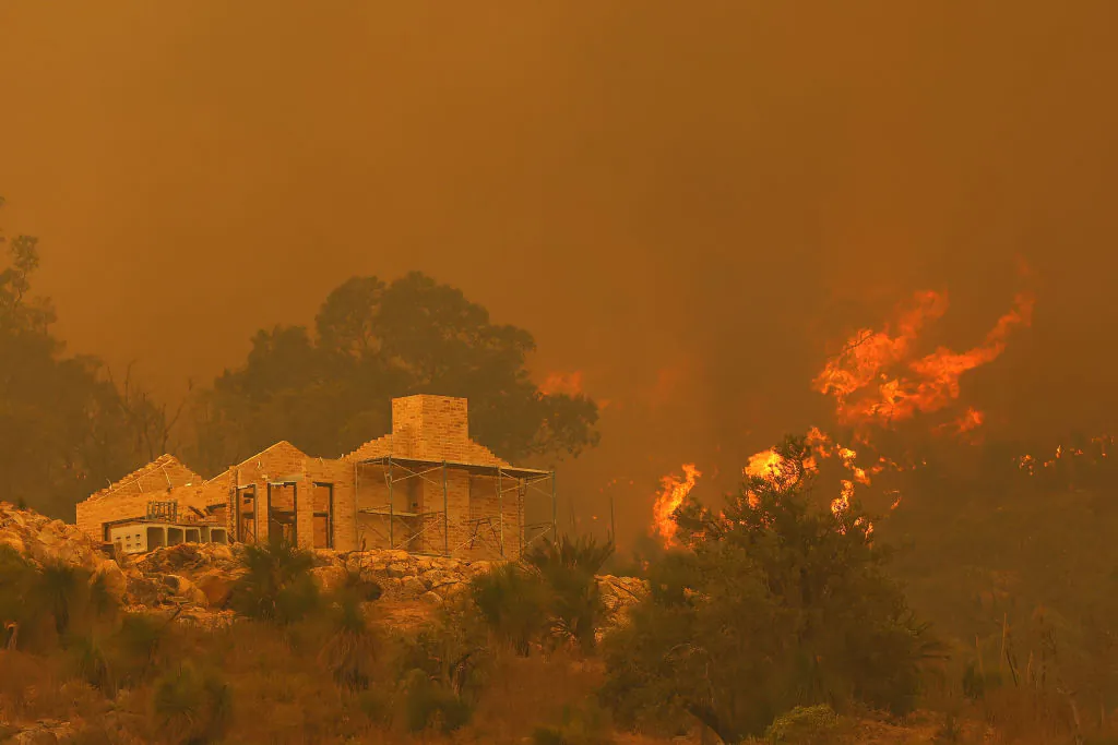 Flames surround a property under construction off Copley Road in Upper Swan on February 02, 2021 in Perth, Australia. (Paul Kane/Getty Images)