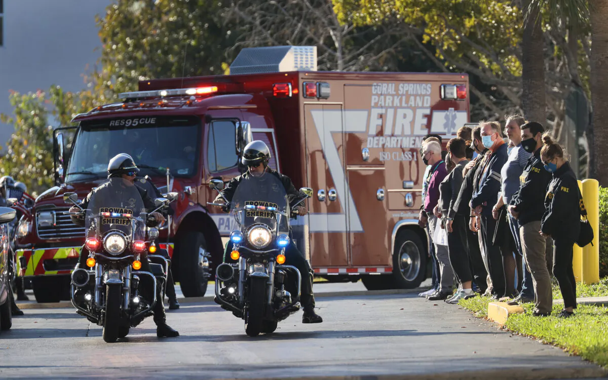 Broward County, Fla., sheriff's officers escort a Coral Springs Parkland Fire Department vehicle as it leaves the Broward County Office of Medical Examiner following the killing of two FBI agents during the serving of a warrant in Sunrise, Fla. (Joe Raedle/Getty Images)