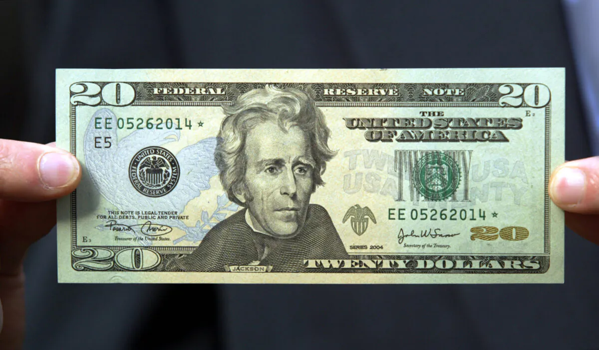 A $20 bill is held by a man in New York City on Oct. 9, 2003. (Chris Hondros/Getty Images)
