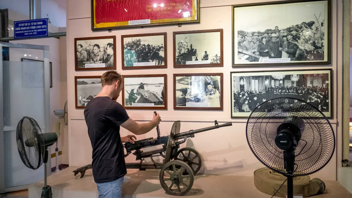 A visitor tries out the machine gun at Vietnam Military History Museum in Hanoi, Vietnam, on May 25, 2016. (Linh Pham/Getty Images)