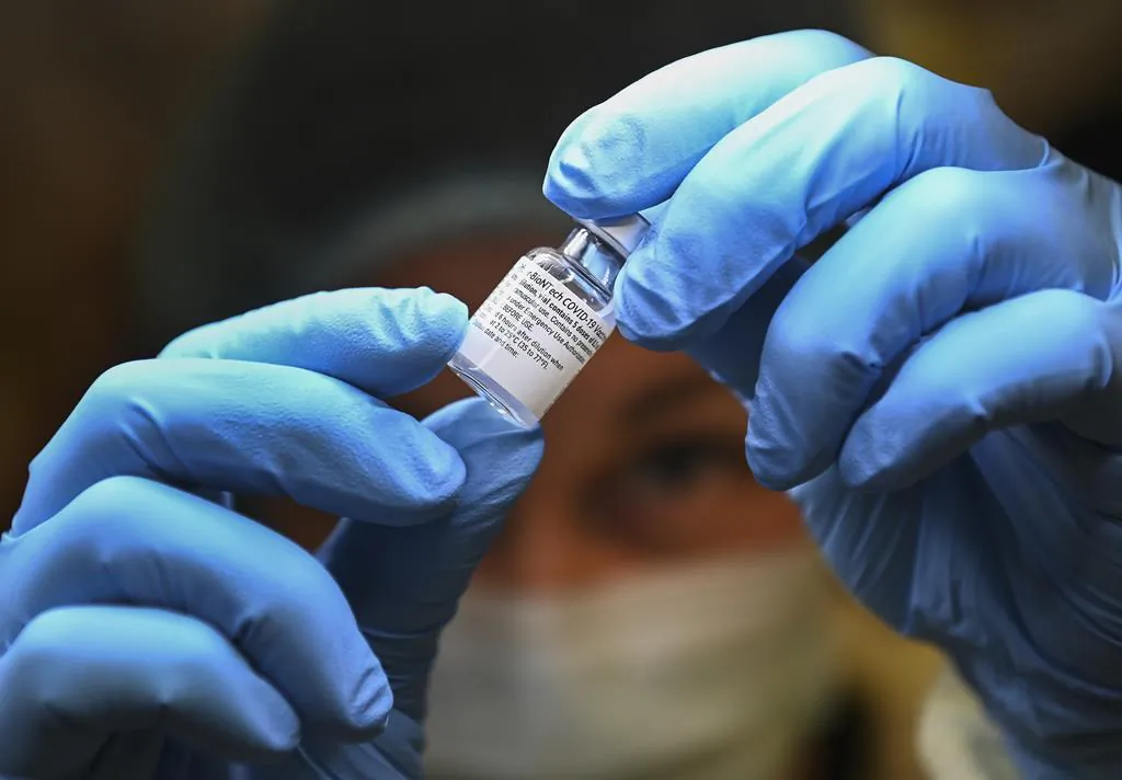 A health-care worker prepares a dose of the Pfizer-BioNTech COVID-19 vaccine at a UHN COVID-19 vaccine clinic in Toronto on Jan. 7, 2021. (Nathan Denette/The Canadian Press)