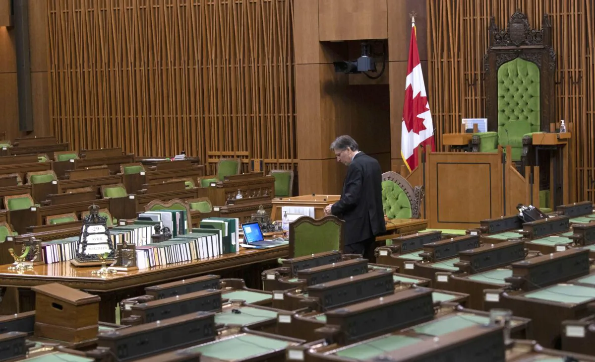 A House of Commons clerk prepares for a committee meeting in the chamber on April 29, 2020. (The Canadian Press/Adrian Wyld)