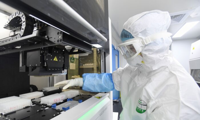 This photo taken on Feb. 6, 2020, shows a laboratory technician working on samples from people to be tested for coronavirus at "Fire Eye" laboratory in Wuhan, China. BGI Group, a genome sequencing company based in southern China, said it opened on Feb. 5 a lab in Wuhan able to test up to 10,000 people per day for the virus. (STR/AFP via Getty Images)