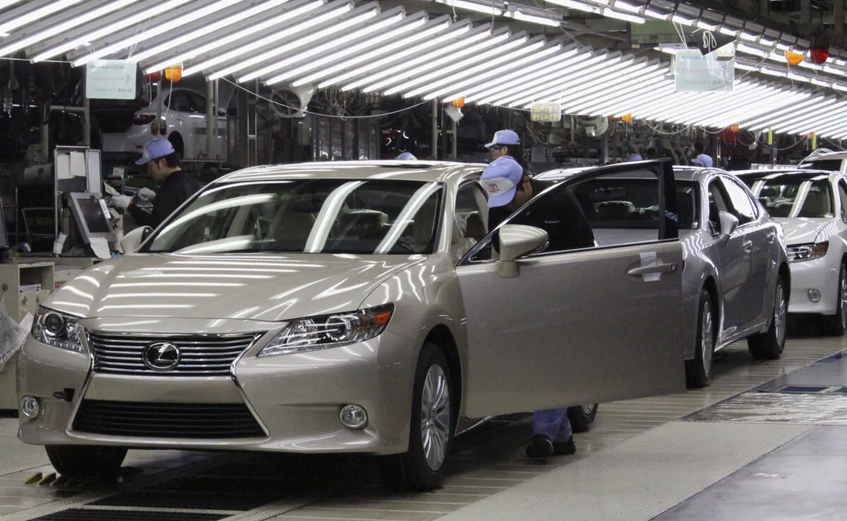 Toyota workers inspect the new Lexus ES vehicles at a Toyota plant in Miyawaka, southern Japan, on July 6, 2012. (Yoko Kubota/File Photo/Reuters)