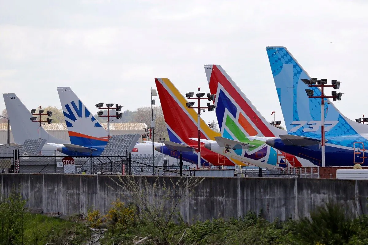 A line of Boeing 737 MAX jets sit parked on the airfield adjacent to a Boeing production plant in Renton, Wash., on April 20, 2020. (Elaine Thompson/File/AP Photo)