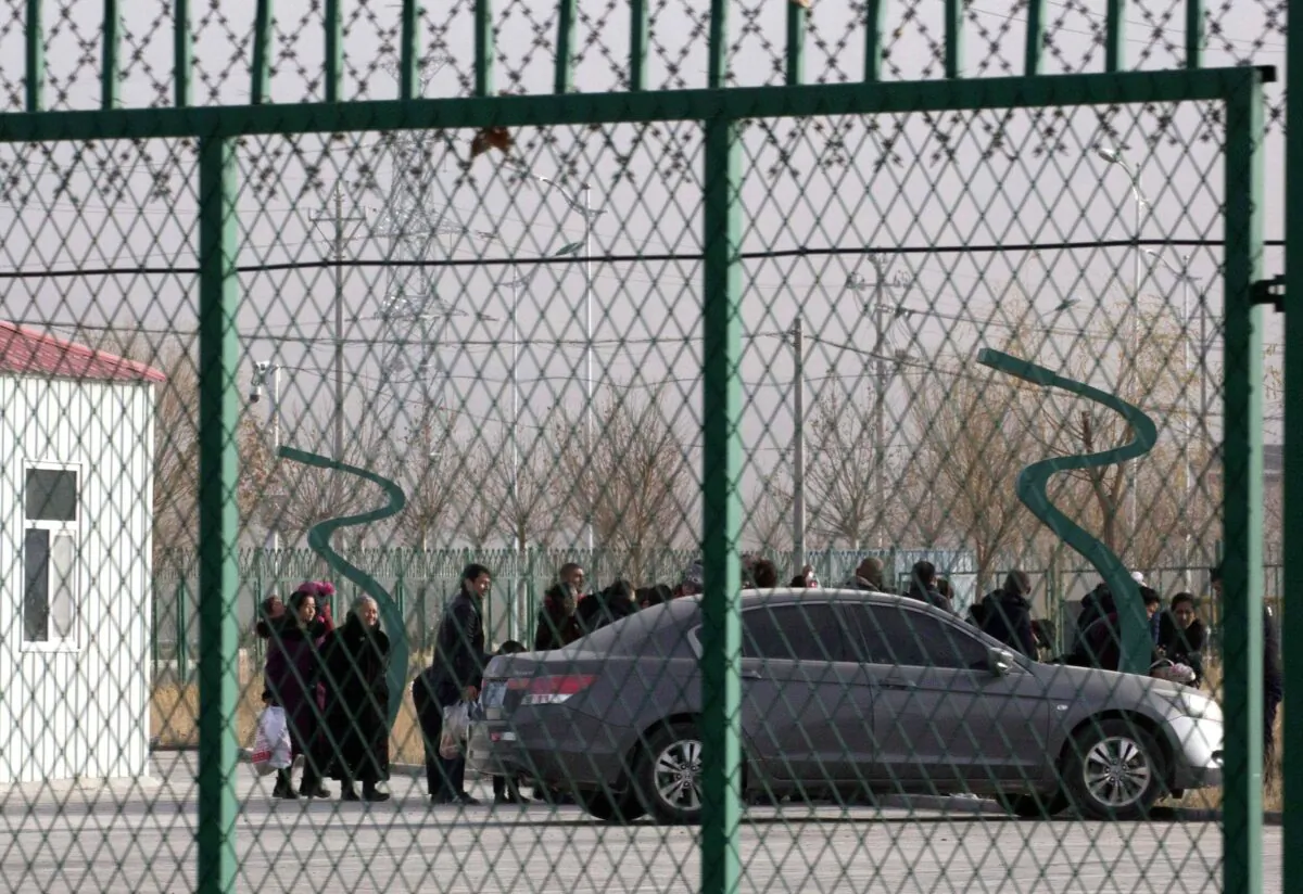 People line up inside the Artux City Vocational Skills Education Training Service Center which has been revealed to be a forced indoctrination camp, in Artux in western China's Xinjiang region on Dec. 3, 2018. (AP Photo/Ng Han Guan, File)