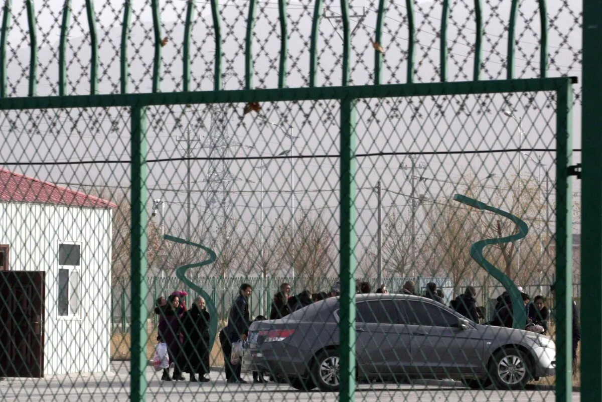 People line up inside the Artux City Vocational Skills Education Training Service Center, which has been revealed to be a forced indoctrination camp, in Artux in western China's Xinjiang region on Dec. 3, 2018. (AP Photo/Ng Han Guan, File)