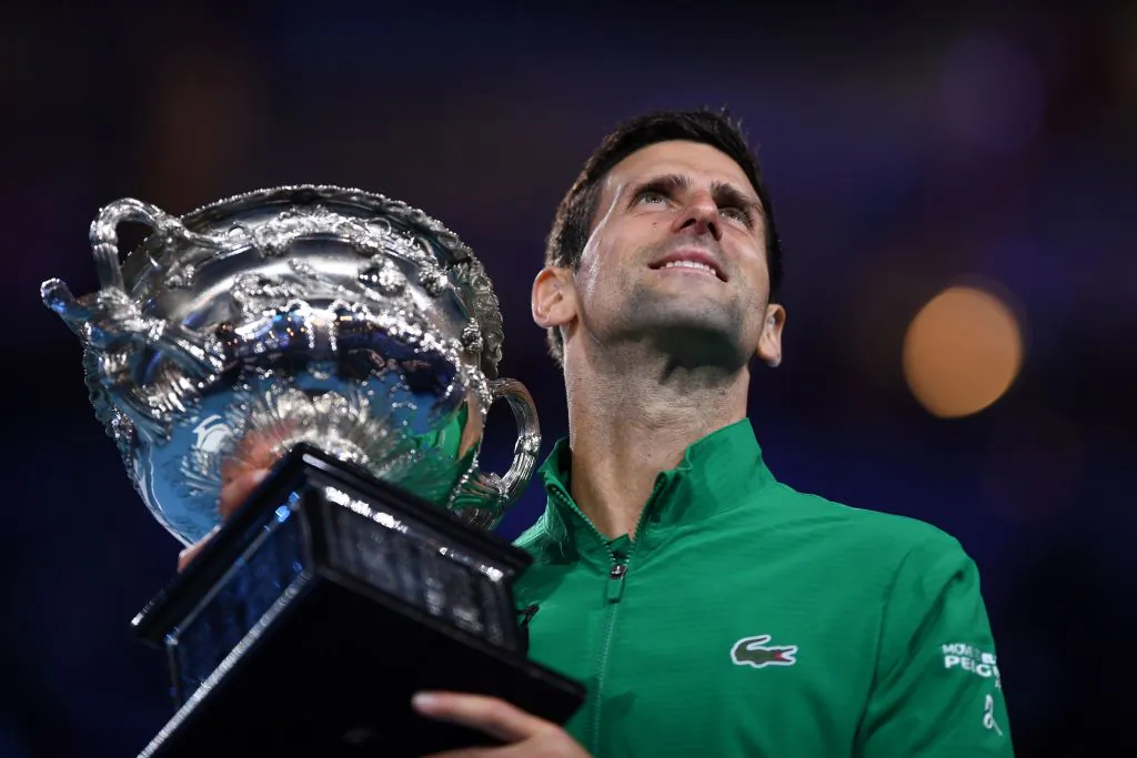 Serbia's Novak Djokovic holds the trophy after beating Austria's Dominic Thiem in their men's singles final match of the Australian Open in Melbourne on February 3, 2020. (SAEED KHAN/AFP via Getty Images)