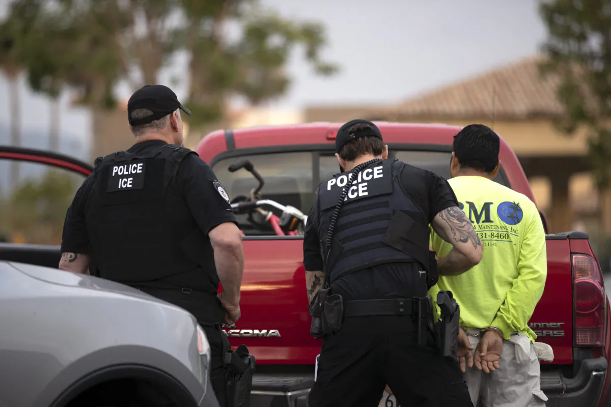 U.S. Immigration and Customs Enforcement (ICE) officers detain a man during an operation in Escondido, Calif., on July 8, 2019. (Gregory Bull/AP Photo)