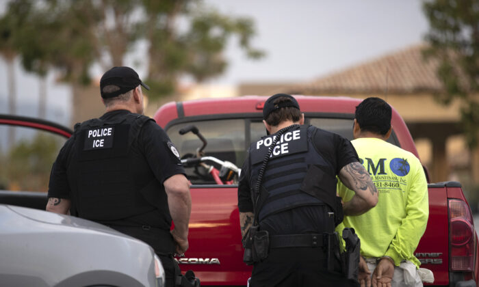 U.S. Immigration and Customs Enforcement (ICE) officers detain a man during an operation in Escondido, Calif., on July 8, 2019. (Gregory Bull/AP Photo)