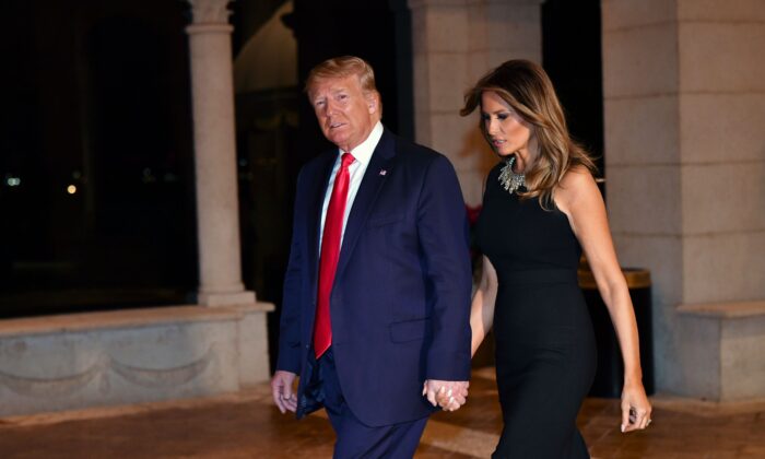 Then-President Donald Trump and First Lady Melania Trump arrive for a Christmas Eve dinner with their family at Mar-a-Lago in Palm Beach, Fla., on Dec. 24, 2019. (Nicholas Kamm/AFP via Getty Images)