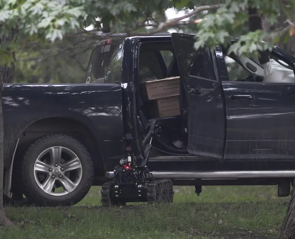 A police robot approaches a pickup truck inside the grounds of Rideau Hall in Ottawa on July 2, 2020. (The Canadian Press/Adrian Wyld)