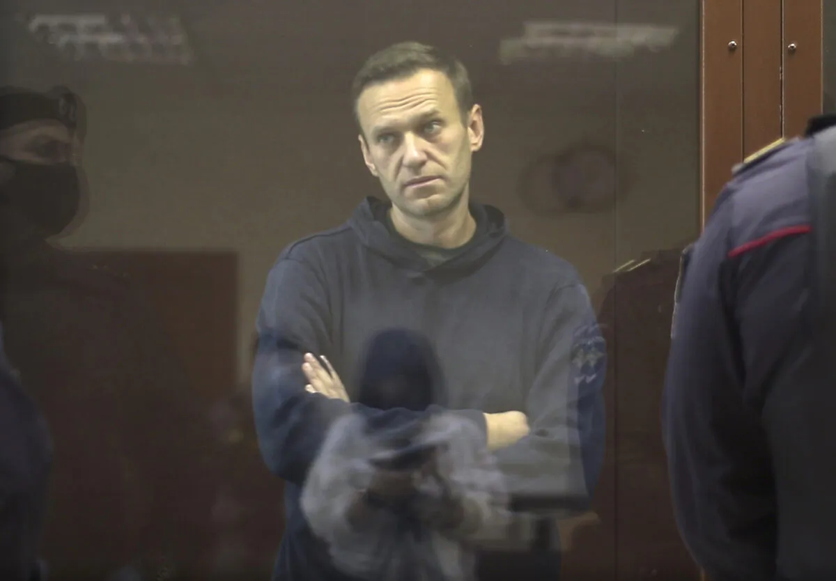 Alexei Navalny stands in a cage during a hearing on his charges for defamation, in the Babuskinsky District Court in Moscow, Russia, on Feb. 5, 2021. (Babuskinsky District Court via AP)
