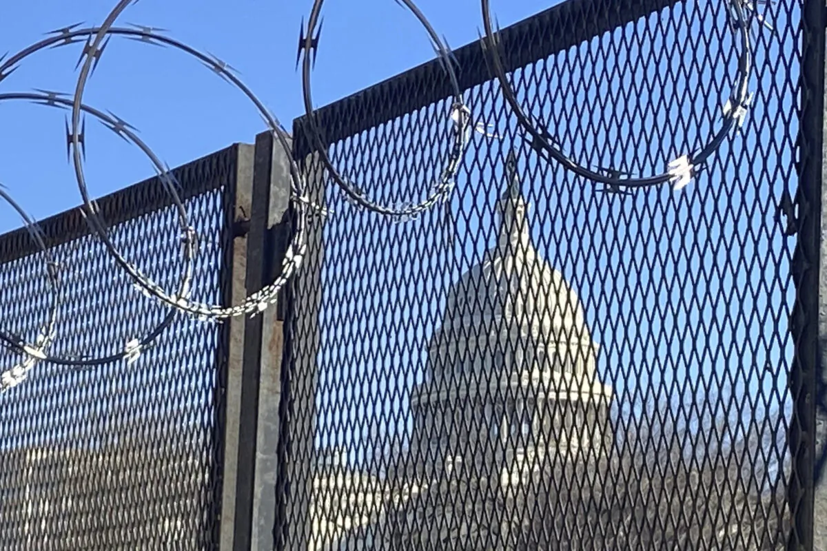 Riot fencing and razor wire reinforce the security zone on Capitol Hill, in Washington, on Jan. 23, 2021. (AP Photo/Eileen Putman)