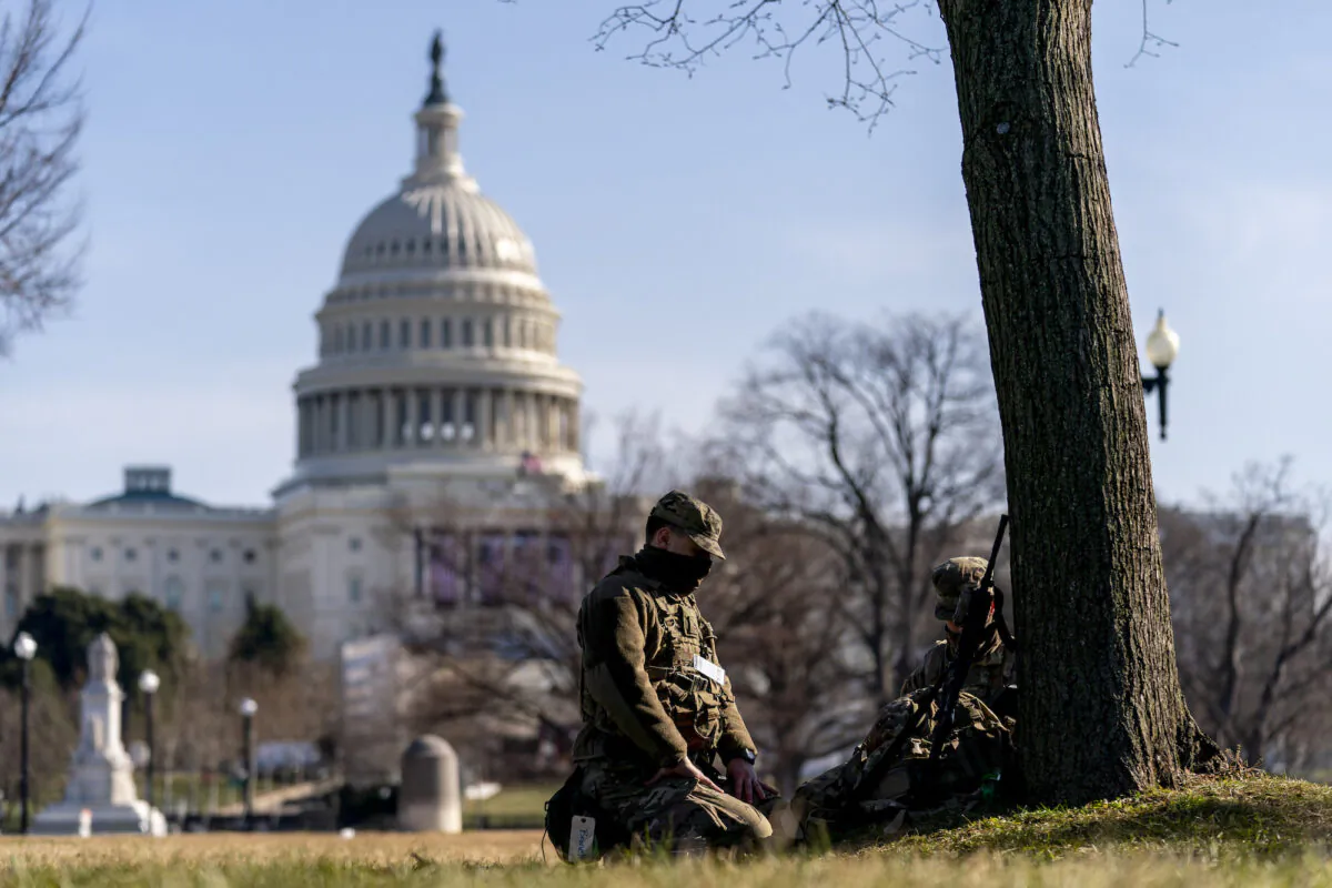 Members of the National Guard work outside the U.S Capitol building on Capitol Hill in Washington on Jan. 20, 2021. (/Andrew Harnik/AP Photo)