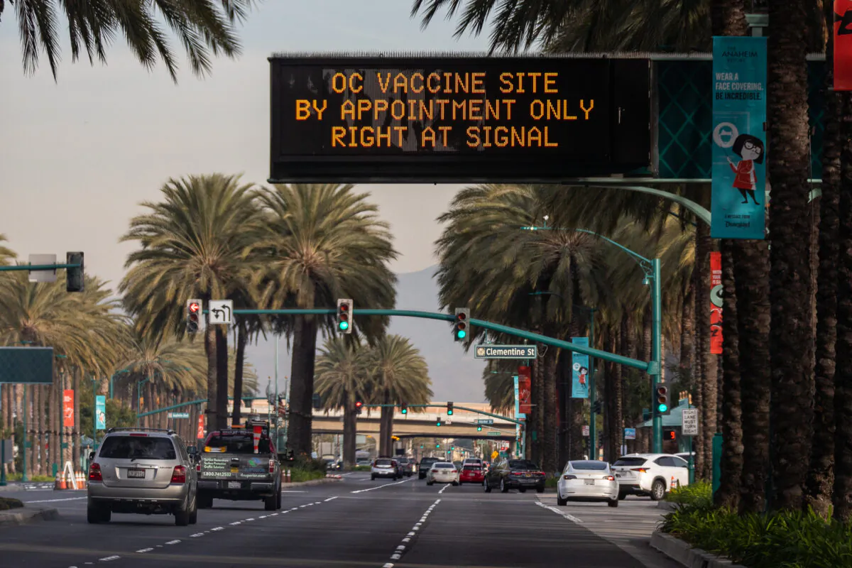 A sign communicates the arrival of a coronavirus vaccination center set up in a parking area of Disneyland themepark in Anaheim, Calif., on Jan, 13, 2021. (John Fredricks/The Epoch Times)