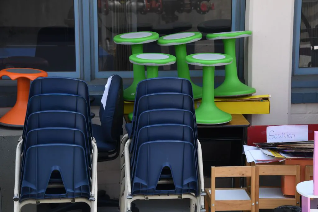 Chairs, desk and other school furniture is stacked outside a classroom at a public elementary school in Glendale, California just north of Los Angeles, August 17, 2020 amid the coronavirus pandemic. - The school year starts this week with online classes only. (Robyn Beck/AFP via Getty Images)