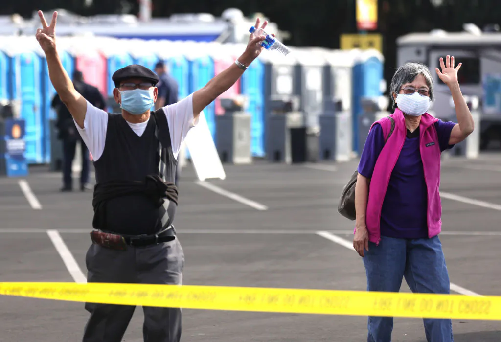 People react after receiving the COVID-19 vaccine at a mass vaccination site in a parking lot for Disneyland Resort on January 13, 2021 in Anaheim, California. (Mario Tama/Getty Images)