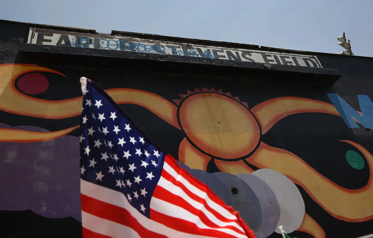 An American flag flies on a car next to a mural at Maywood Park in Maywood, Calif., on June 23, 2010. (David McNew/Getty Images)