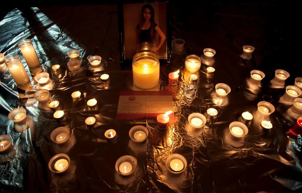 Candles are seen in front of a picture of Amanda Todd during a memorial for her in Surrey, B.C., on Oct. 19, 2012. (The Canadian Press/Jonathan Hayward)