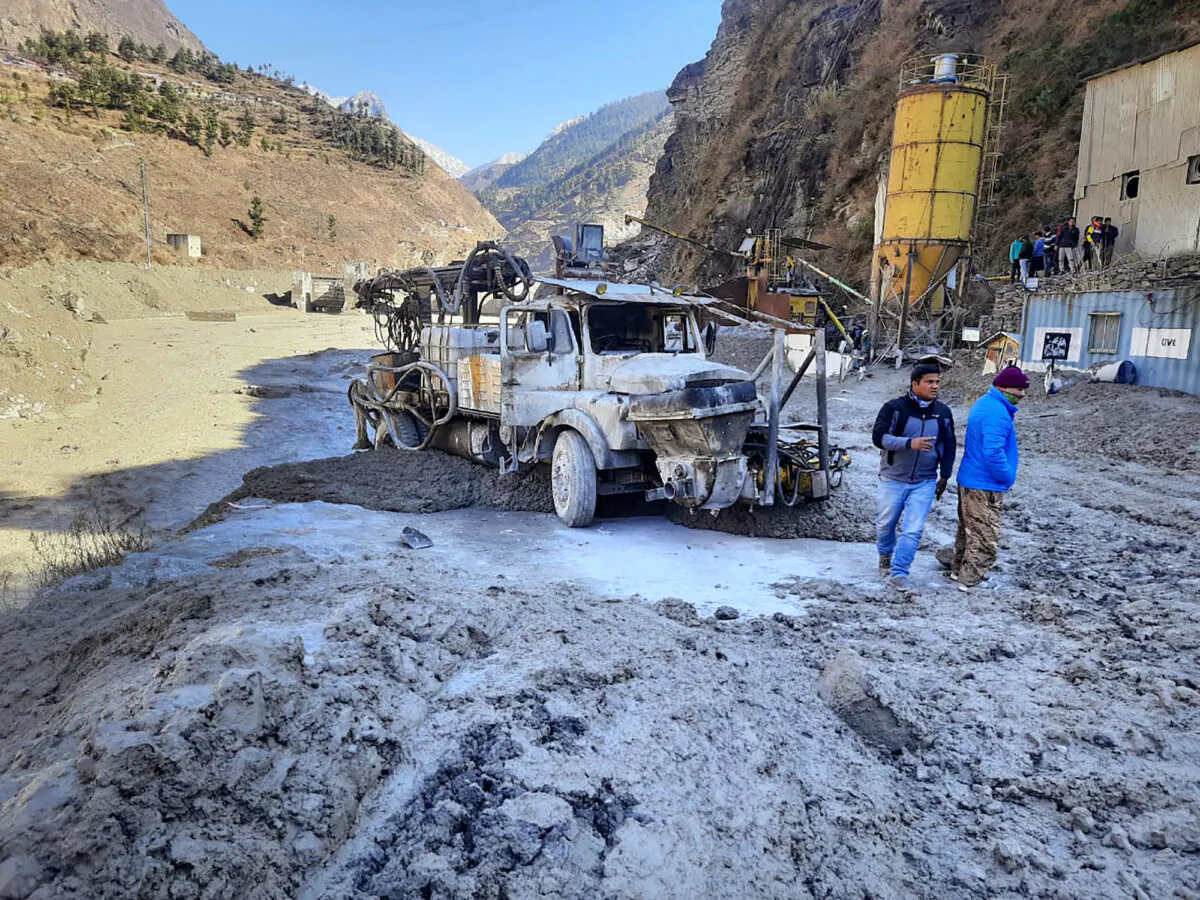 People inspect the site near the damaged Dhauliganga hydropower project at Reni village in Chamoli district after a portion of Nanda Devi glacier broke off in Tapovan area of the northern state of Uttarakhand, on Feb. 7, 2021. (AP Photo)