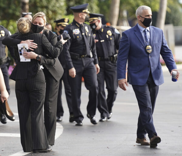 Law enforcement representatives embrace