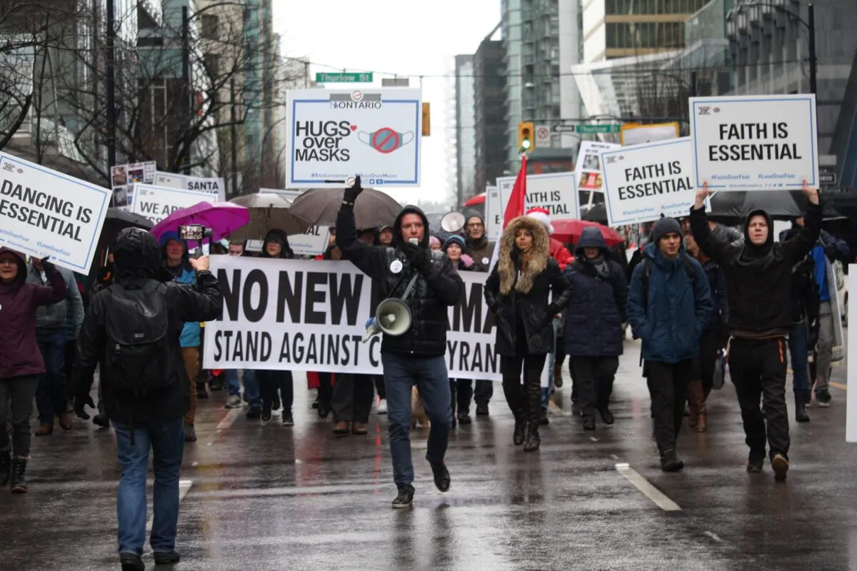 Founder of We Are All Essential Vladislav Sobolev (C) leads a march during an anti-lockdown protest in Vancouver on Dec. 27, 2020. (Courtesy of Vladislav Sobolev)