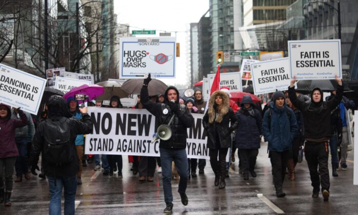 Founder of We Are All Essential Vladislav Sobolev (C) leads a march during an anti-lockdown protest in Vancouver on Dec. 27, 2020. (Courtesy of Vladislav Sobolev)