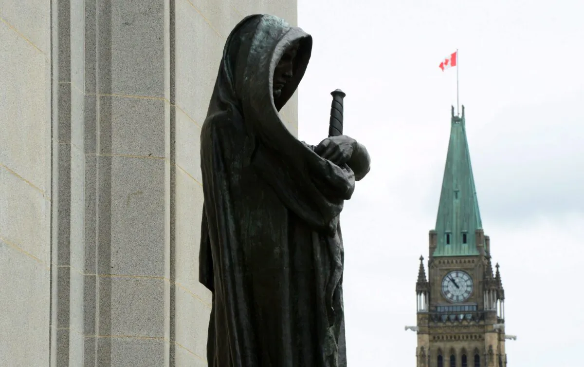 The Peace Tower on Parliament Hill is seen behind the justice statue at the Supreme Court of Canada, in Ottawa in a file photo. (Sean Kilpatrick/The Canadian Press)