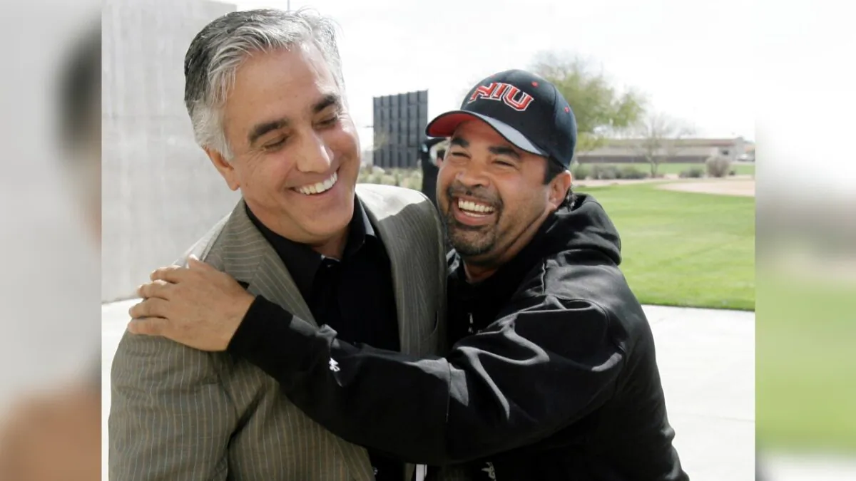 Chicago White Sox manager Ozzie Guillen (R) jokes with ESPN's Pedro Gomez after a news conference during the first day of baseball spring training for pitchers and catchers, in Tucson, Ariz., on Feb. 16, 2008. (M. Spencer Green/File/AP Photo)