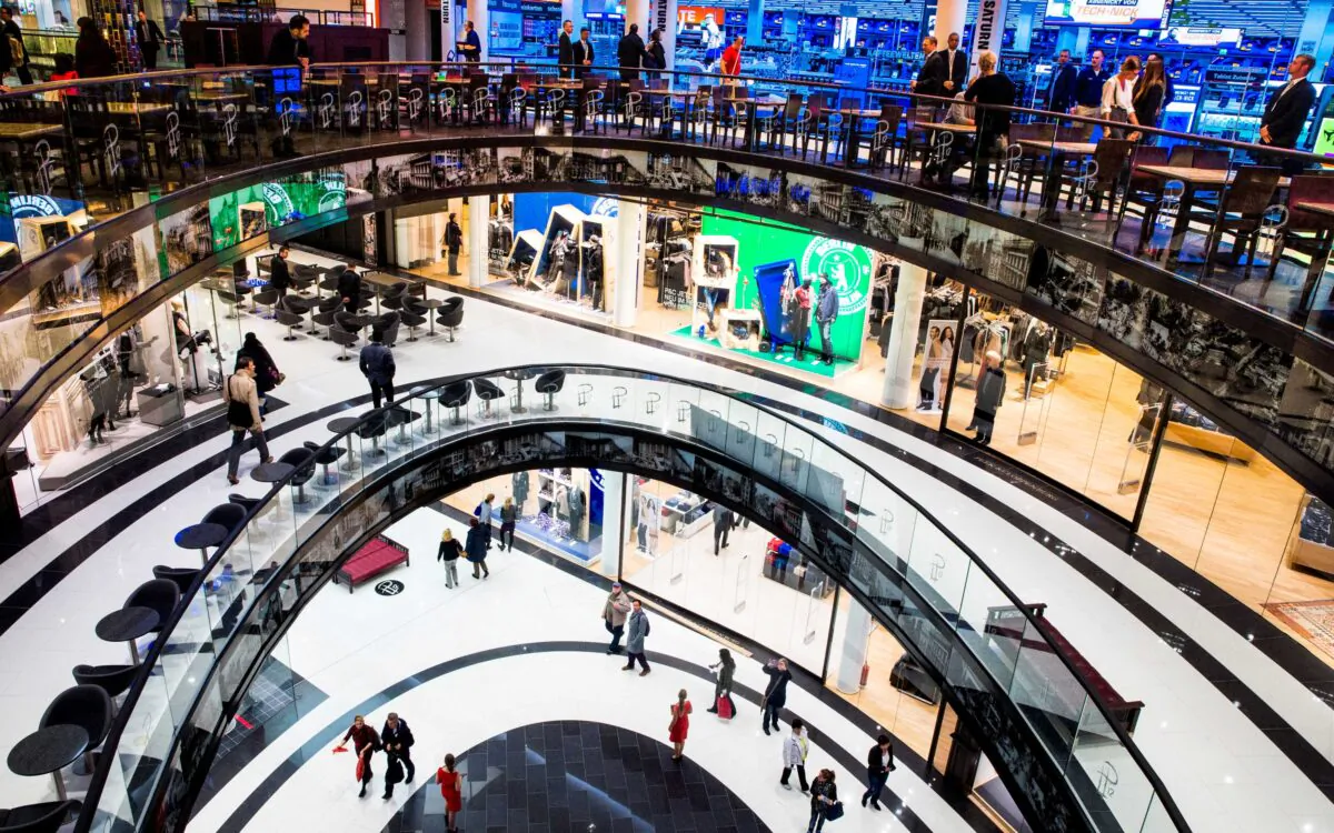 People walk through the Mall of Berlin shopping center during its opening night in Berlin on Sept. 24, 2014. (Thomas Peter/Reuters)