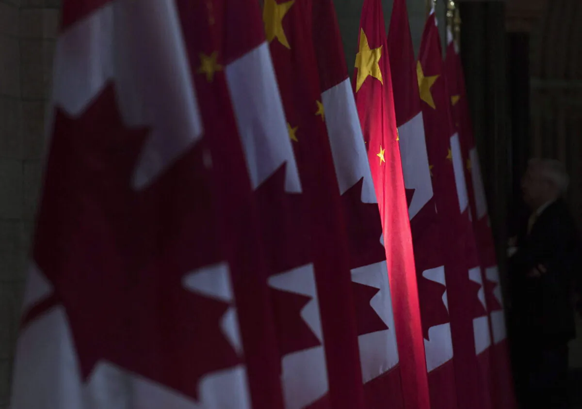A Chinese flag is illuminated by sunshine in the Hall of Honour on Parliament Hill in Ottawa on Sept. 22, 2016. (The Canadian Press/Adrian Wyld)