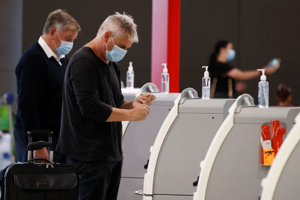 People are seen at Melbourne Airport checking in for flights to New South Wales on Nov. 23, 2020 in Melbourne, Australia. (Daniel Pockett/Getty Images)