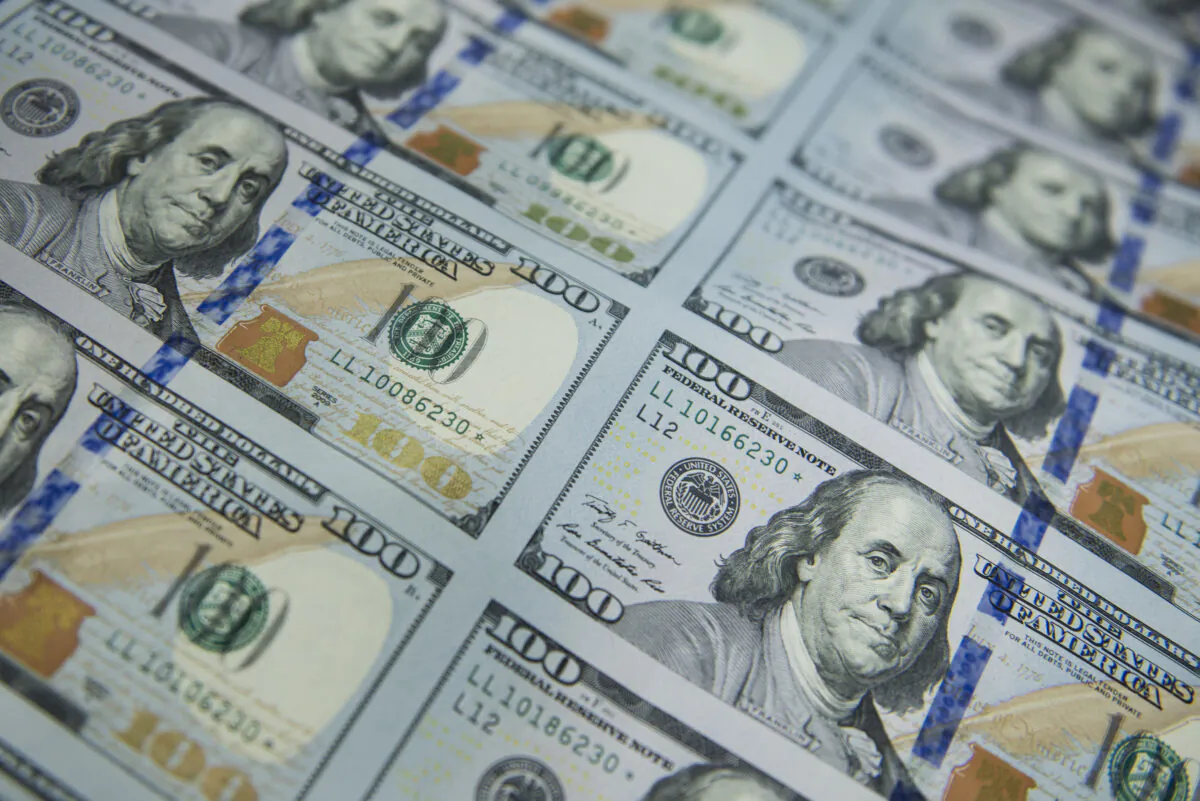New US$100 bills are applied with a serial number, a U.S. Federal Reserve seal, cut and stacked at the U.S. Bureau of Engraving and Printing's Western Currency Facility in Fort Worth, Texas, on Oct. 11, 2013. (Brendan Smialowski/AFP via Getty Images)