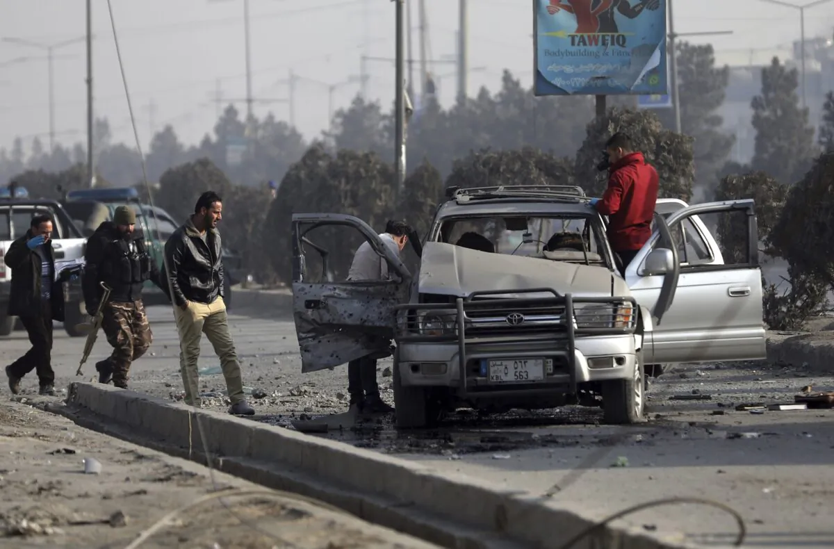 Security personnel inspect the site of a bomb attack in Kabul, Afghanistan, on Feb. 2, 2021. (Rahmat Gul/AP Photo)