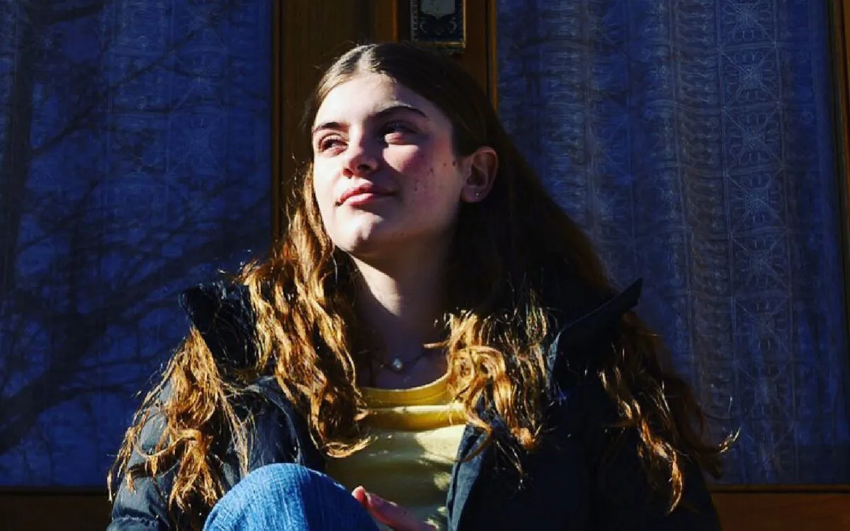 Lena Carson, 14, sits in front of her home in Pittsburgh’s Mexican War Streets neighborhood. (Justin Merriman)