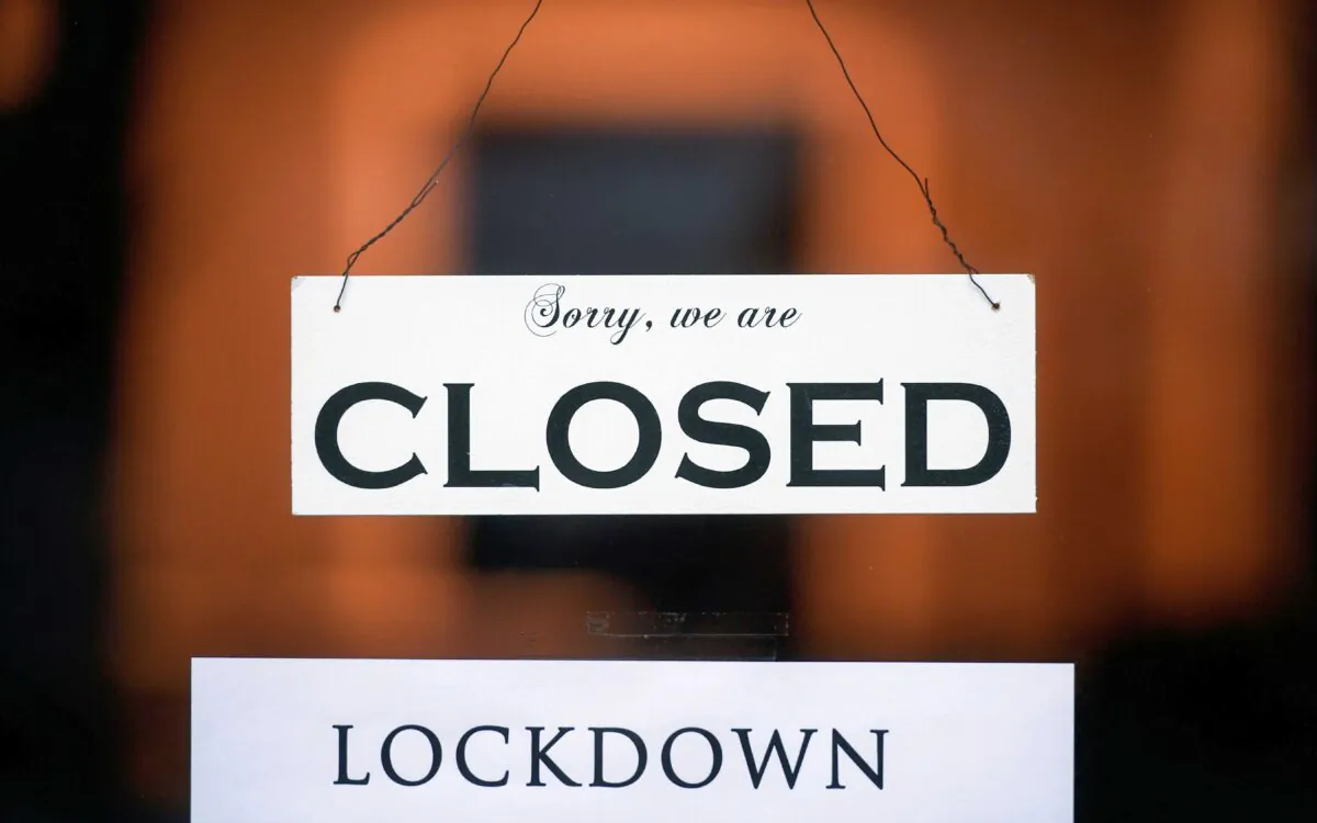 A sign reading 'Sorry, we are closed' is seen at a shop on Jan. 4, 2021. (Ina Fassbender/AFP via Getty Images)