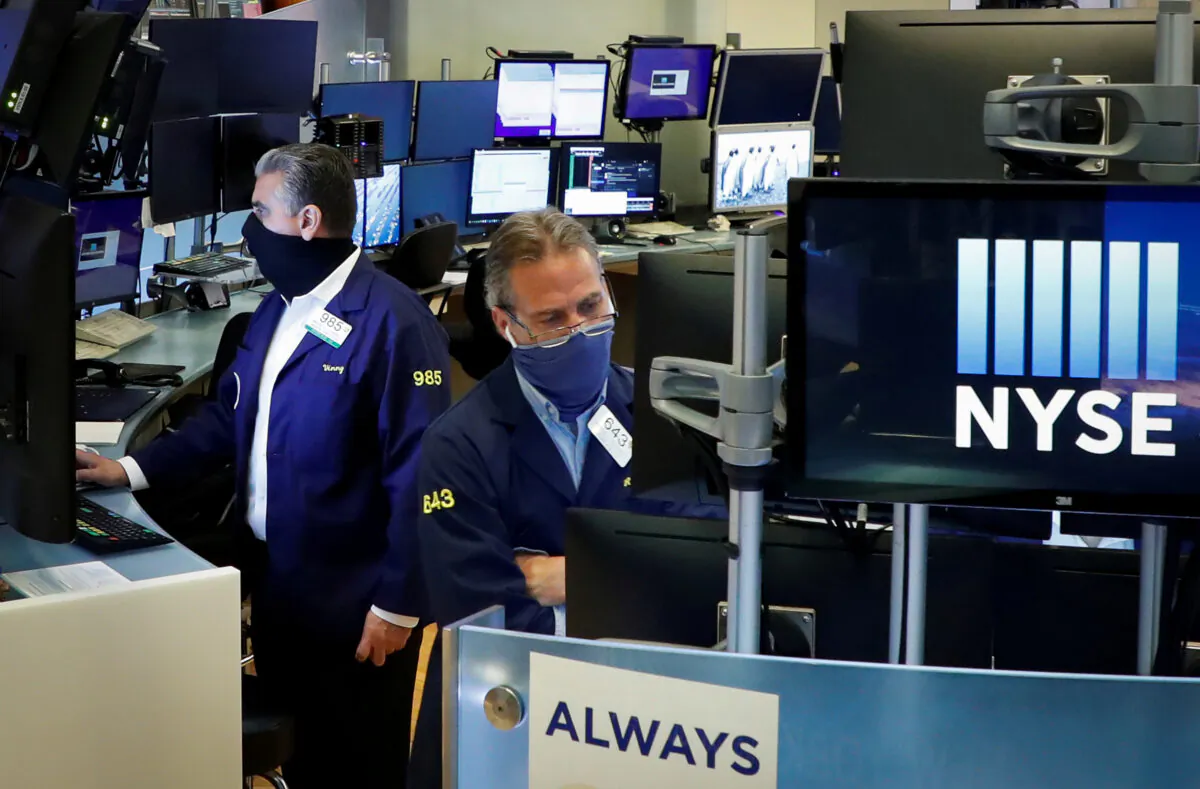 Traders wearing masks work on the floor at the New York Stock Exchange (NYSE) in New York on May 26, 2020. (Brendan McDermid/Reuters)