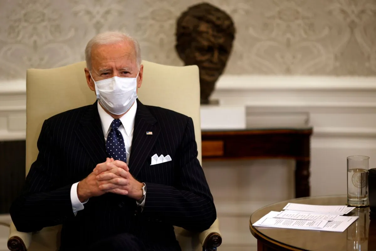 President Joe Biden accompanied by Vice President Kamala Harris and Treasury Secretary Janet Yellen (not pictured) attends a meeting with business leaders at the Oval Office of the White House in Washington on Feb. 9, 2021. (Carlos Barria/Reuters)