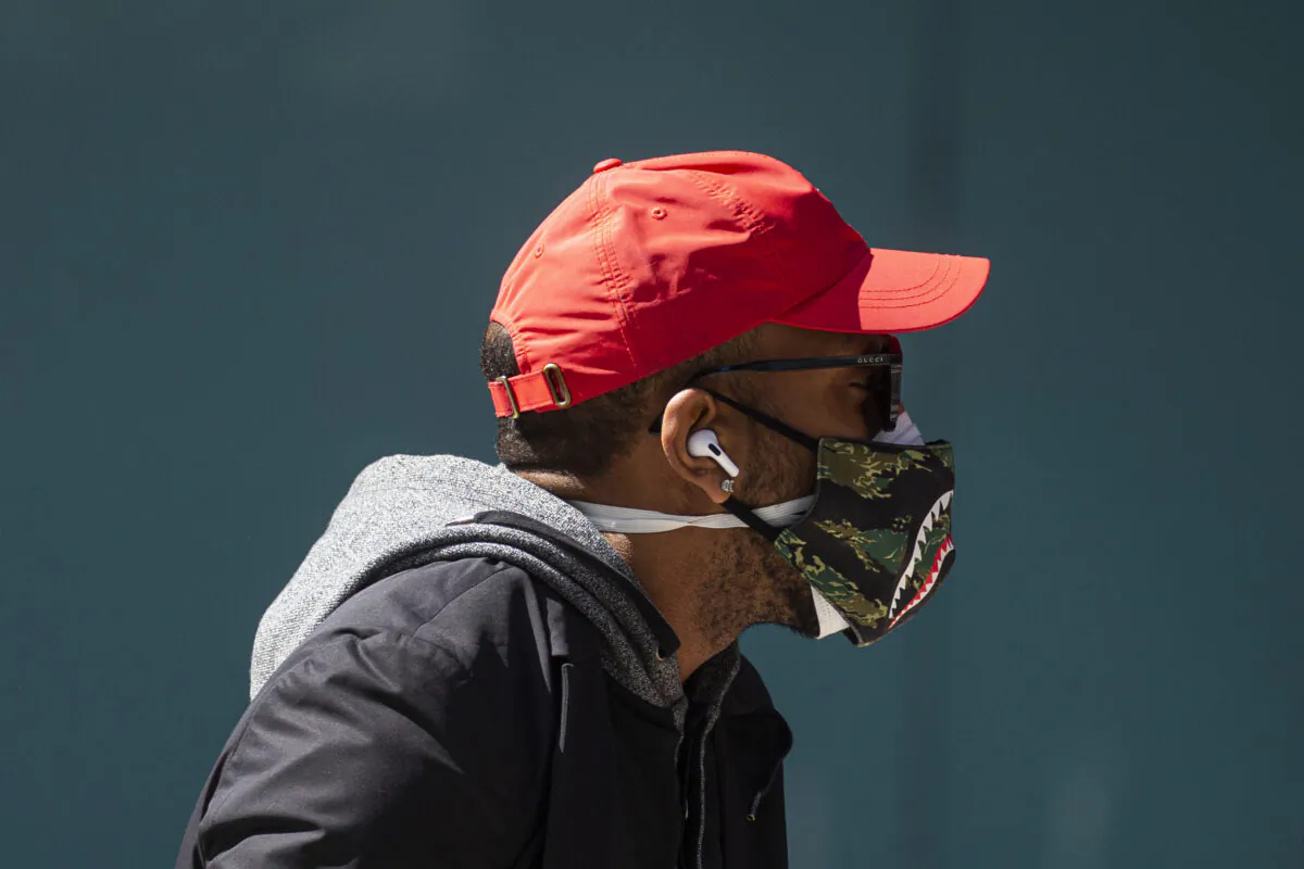 A man wears a double mask as he walks in Times Square in New York City on April 6, 2020. (Kena Betancur/Getty Images)