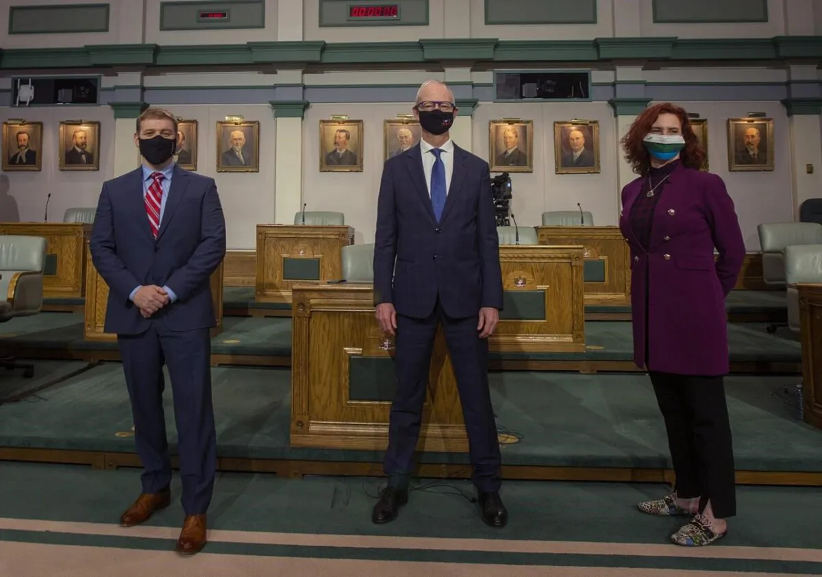Liberal Leader Andrew Furey, left to right, Progressive Conservative Leader Ches Crosbie and NDP Leader Alison Coffin pose for a photo following their televised debate from the floor of the House of Assembly in St. John's N.L. on February 3, 2021. (Paul Daly/The Canadian Press)