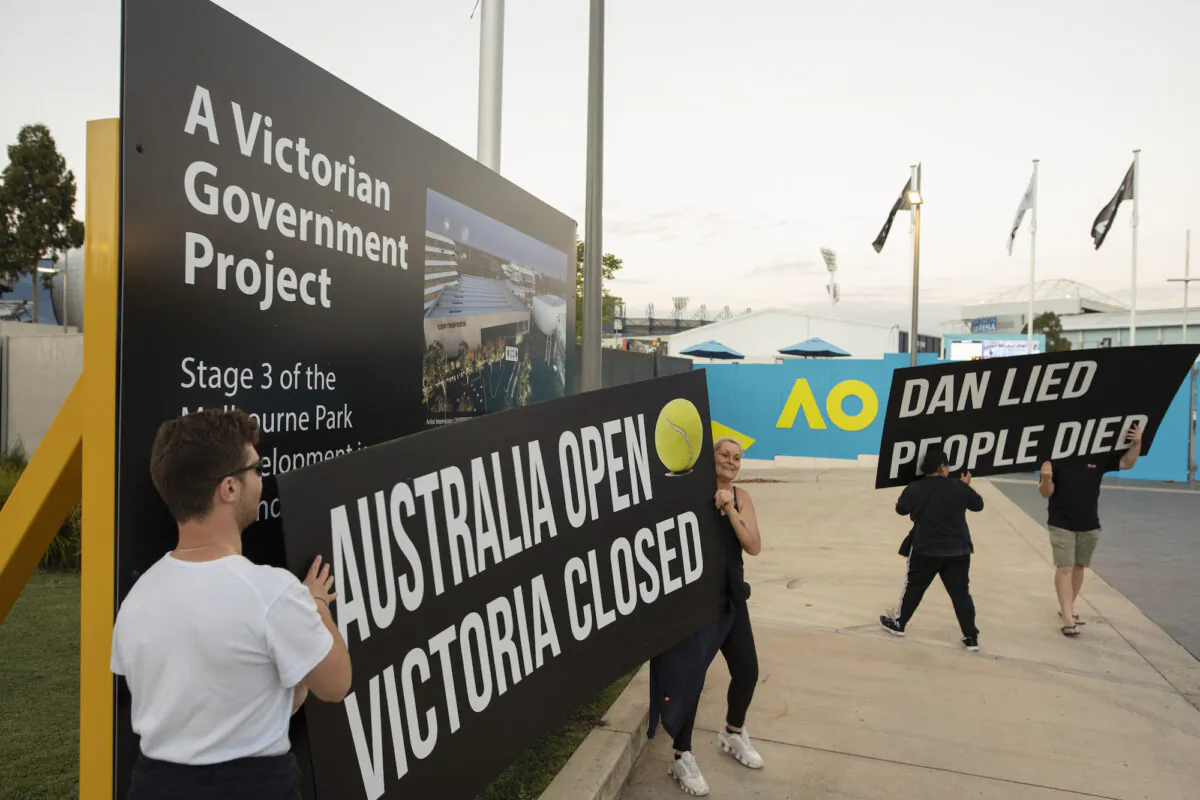 MELBOURNE, AUSTRALIA - FEBRUARY 12:  Anti lockdown protesters  are seen gathering in front of the Rod Lavern Arena, following the announcement of the lockdown on February 12, 2021 in Melbourne, Australia. Victorians have been warned to remain on alert for coronavirus symptoms following new COVID-19 cases detected in the community linked to the Holiday Inn quarantine hotel. (Photo by Diego Fedele/Getty Images)