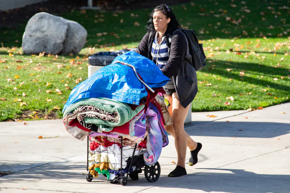 A homeless woman walks without shoes in Santa Ana, Calif., on Dec. 17, 2020. (John Fredricks/The Epoch Times)