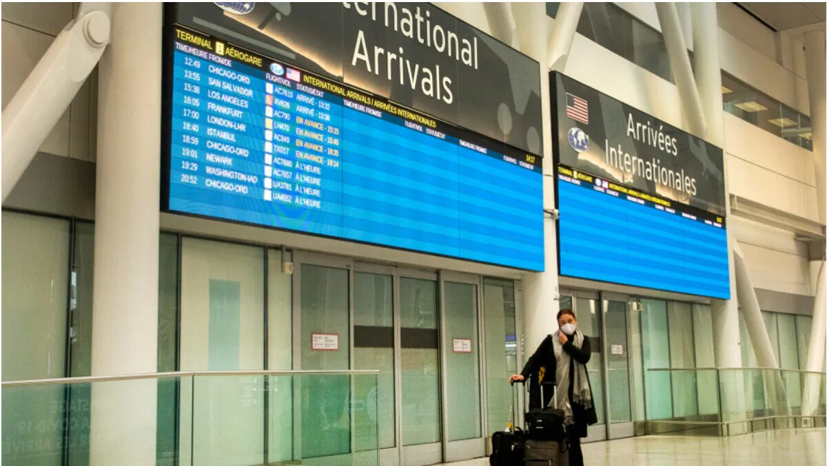 A lone passenger stands outside the International Arrivals area at Pearson Airport in Toronto on January 26, 2021. (Frank Gunn/The Canadian Press)