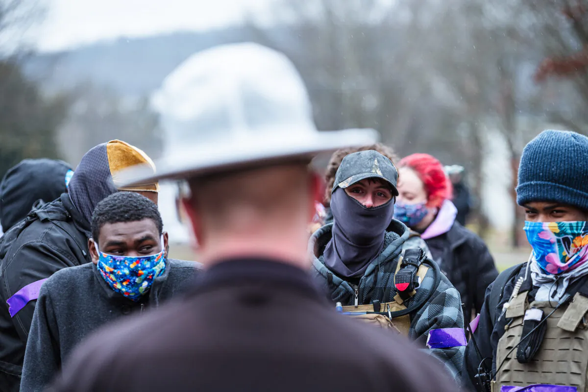 Armed members of the left-wing subsection of the militia coined the Boogaloo Boys converse with Kentucky State troopers outside of the Capitol in Frankfort, Kentucky, on Jan. 17, 2021. (Jon Cherry/Getty Images)