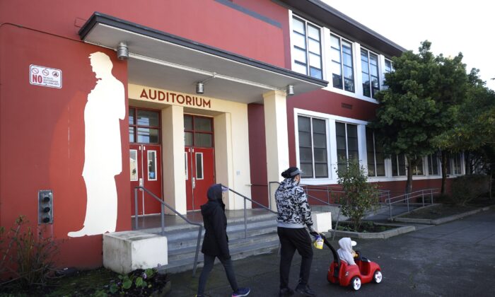Pedestrians walk by a mural of Abraham Lincoln outside of Abraham Lincoln High School in San Francisco, Calif., on Dec. 17, 2020. (Justin Sullivan/Getty Images)