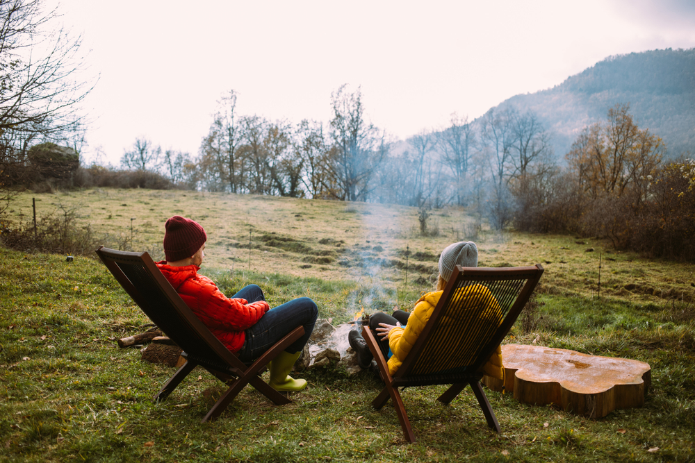 Couple,In,Warm,Puffy,Jackets,Sit,On,Sun,Chairs,In