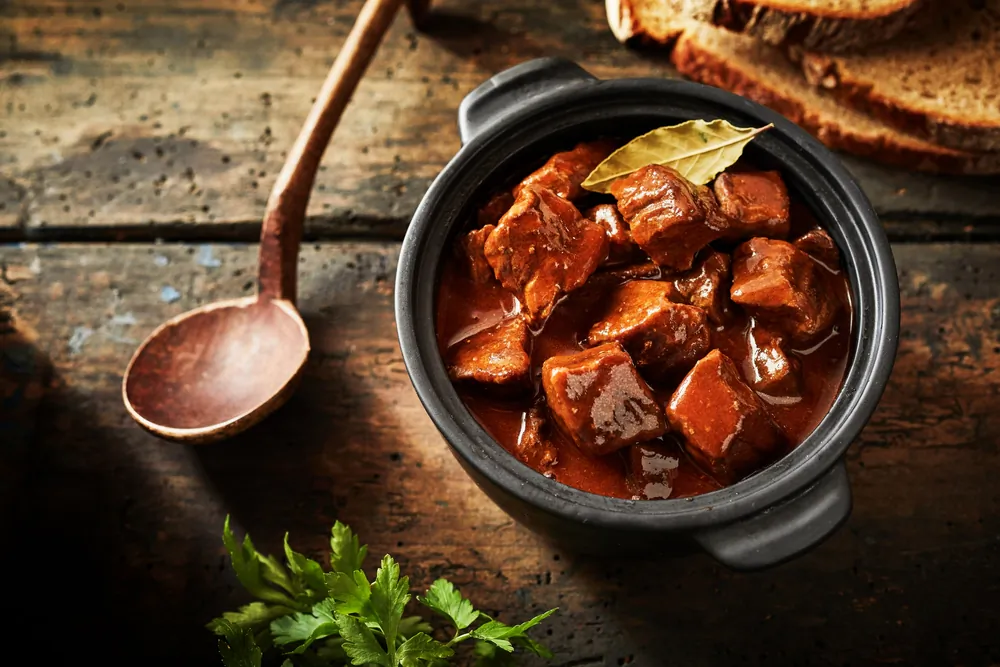 Hungarian goulash may have as many variations as there are home cooks, but generally involves chunks of beef simmered until tender, with a generous helping of sweet paprika. (stockcreations/Shutterstock)