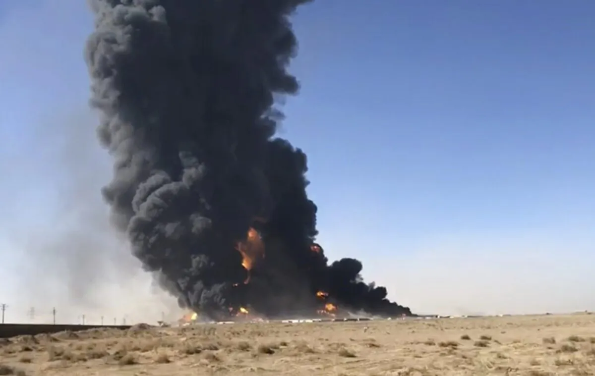 In this still image taken from video, smoke rises from fuel tankers at the Islam Qala border with Iran, in Herat Province, west of Kabul, Afghanistan on Feb. 13, 2021. (AP Photo)