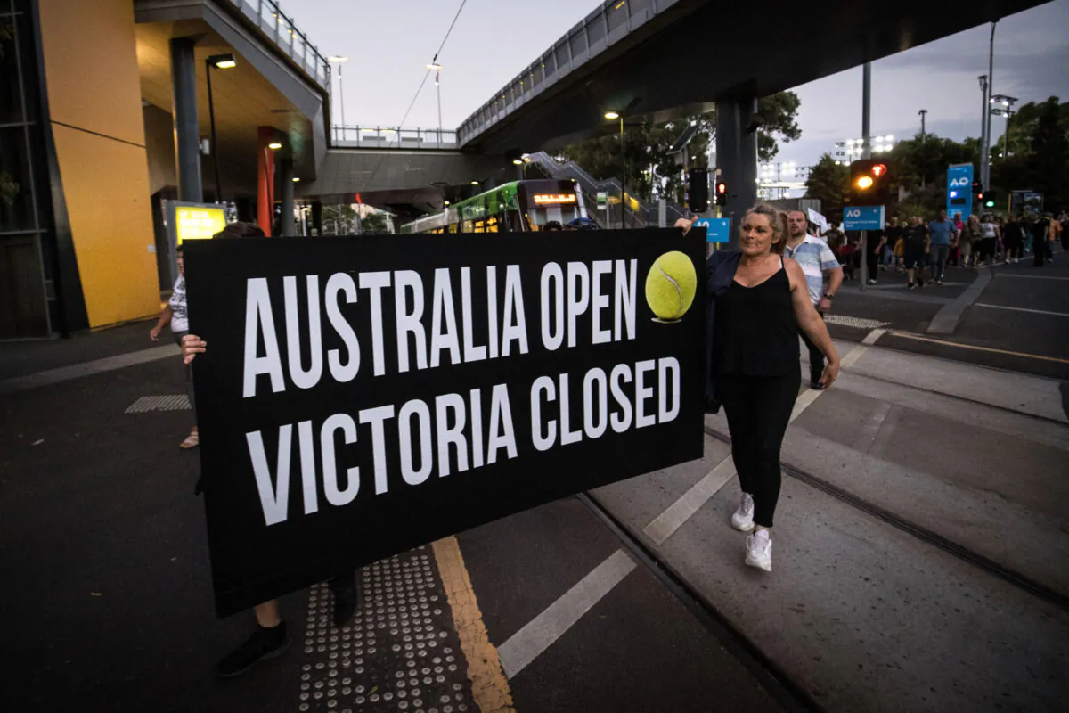 People are seen protesting outside Melbourne Park where the Australian Open is being held on Feb. 12, 2021. (Darrian Traynor/Getty Images)